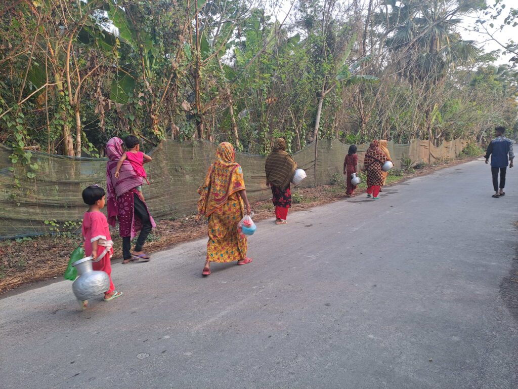 Women and children walking to collect water