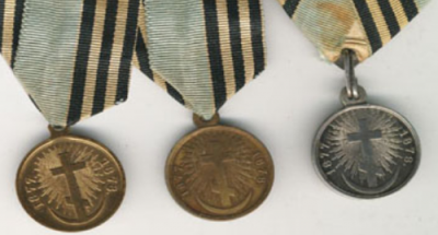 Old medals with emblems of orthodox cross and crescent moon.