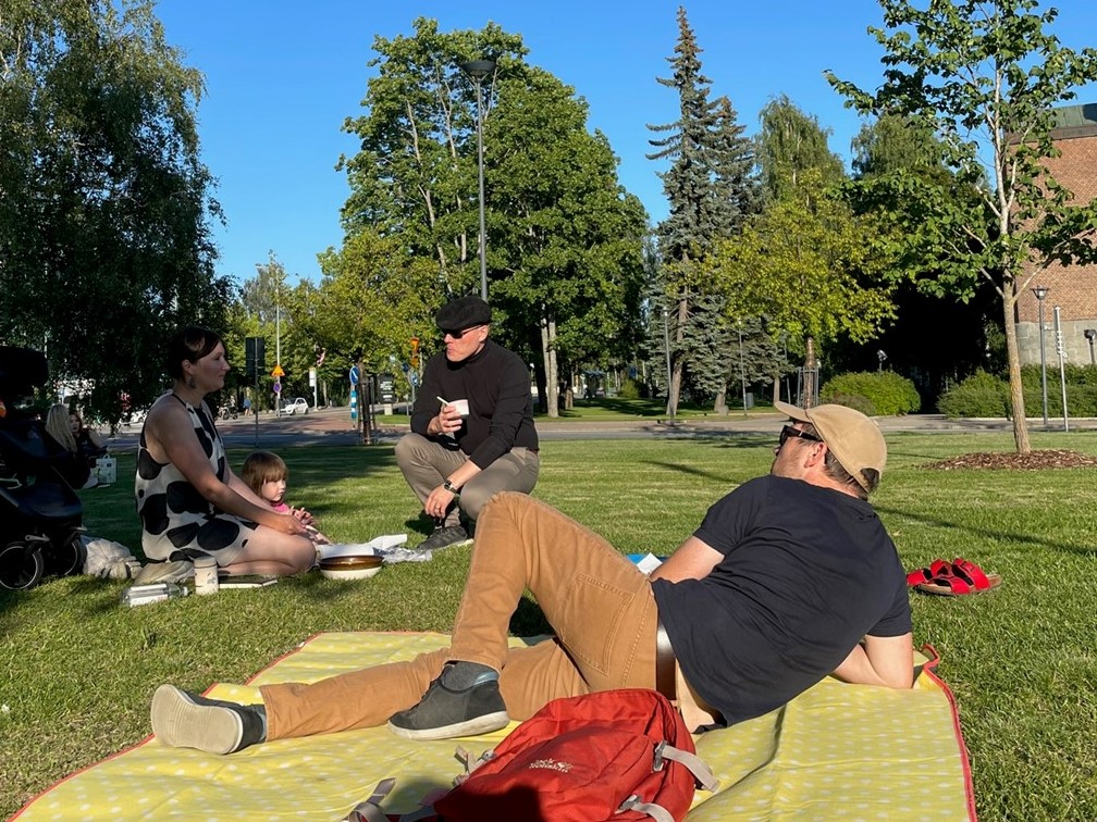 group of people having a picnic in a park