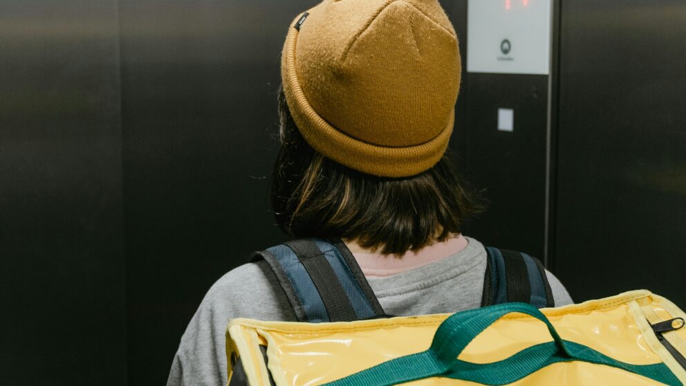 Food delivery courier in an elevator