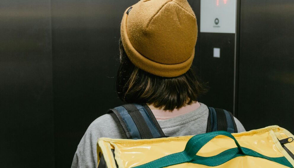 Food delivery courier in an elevator