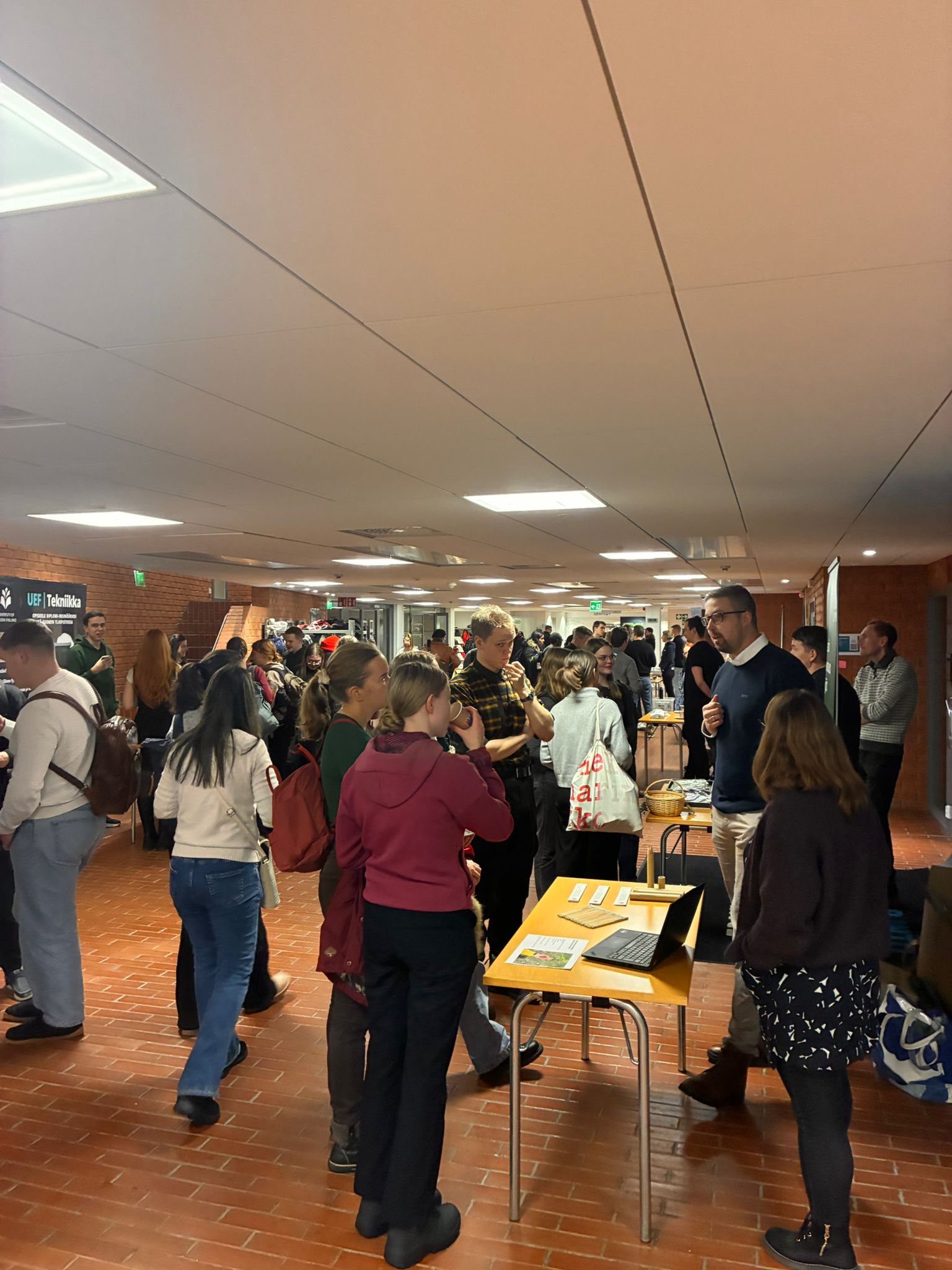 Student meeting company representatives in the Metria lobby