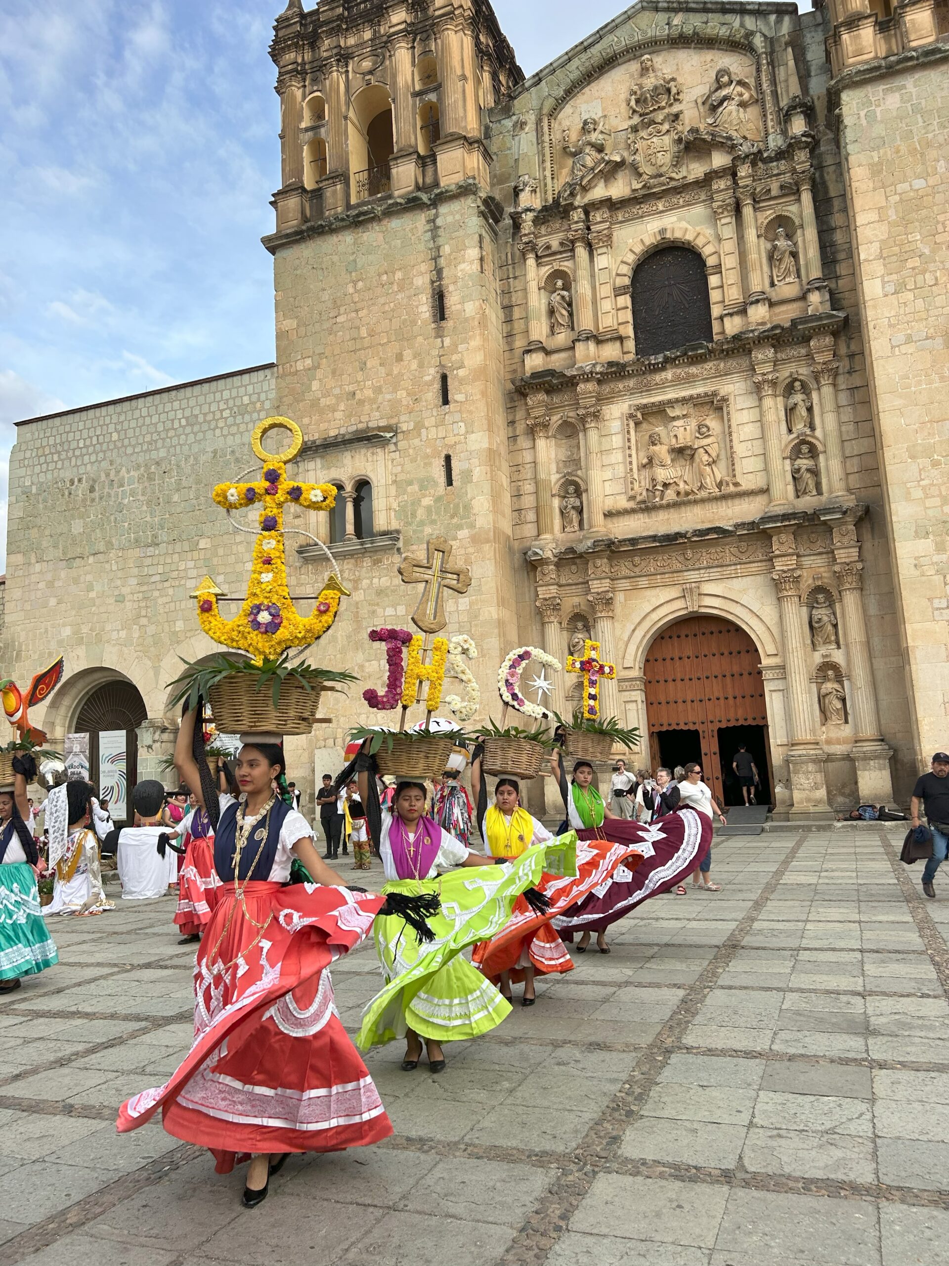 Dancers on street, dressed in traditional dresses.