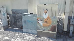 Street view, painting with a fox in an electrical center.