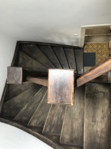 Staircase “Steep down” with wooden steps.