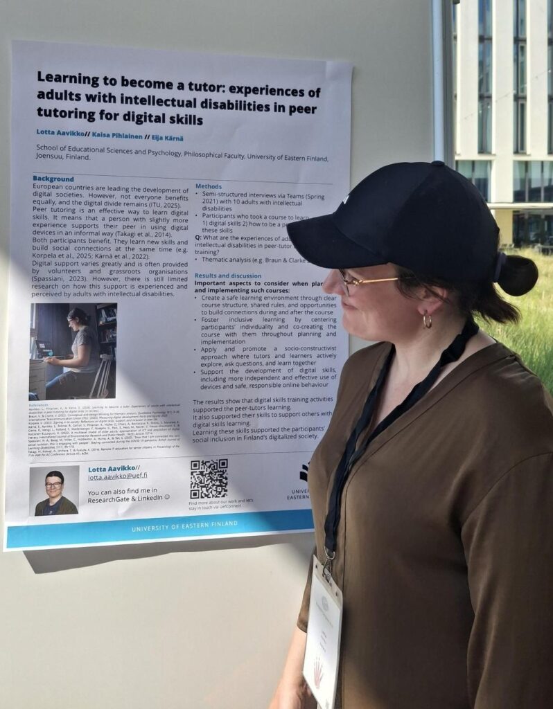 In the picture researcher is looking at the poster which is hanging on the wall.