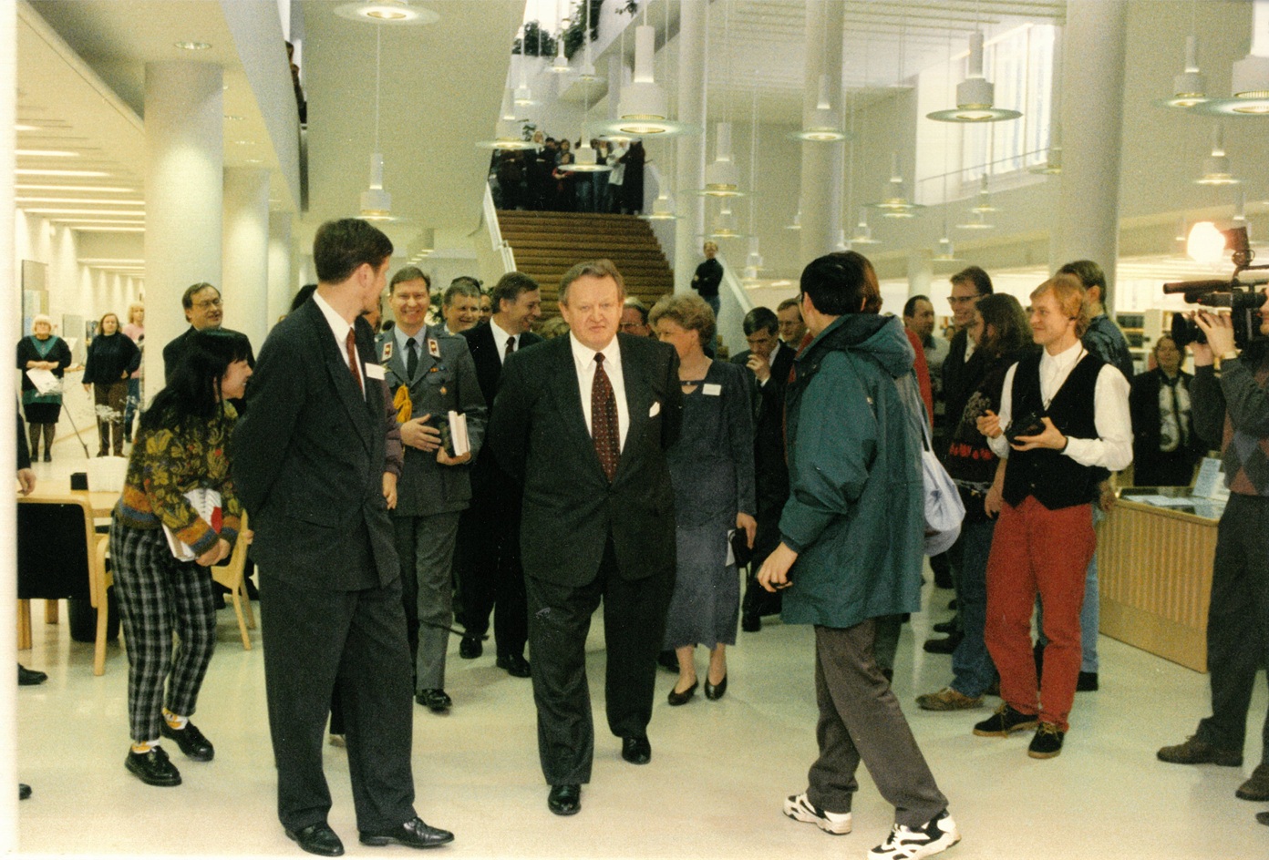 A smiling crowd in the library hall.